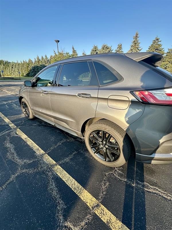 2024 Ford Edge ST-Line, rear three-quarter, Carbonized Grey over black rims